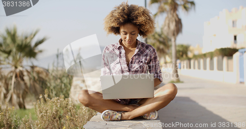 Image of Girl Browsing A Laptop In A Bench