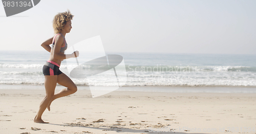 Image of Woman Running On The Beach