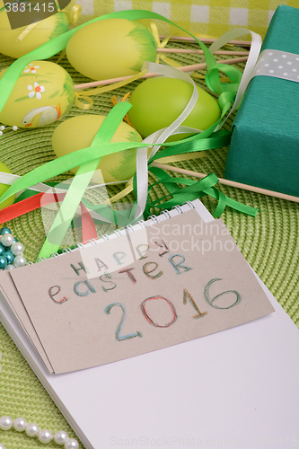 Image of Easter eggs and invitation note. happy easter