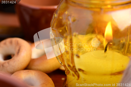 Image of candles in glass burning romantic celecration concept wooden kitchen close up