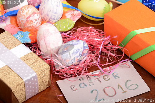 Image of Happy Easter invitation card, hand made eggs at a gift box