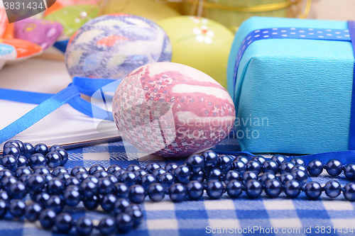 Image of Assorted Easter coloured eggs in the paper egg box