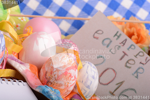 Image of hand made eggs at a gift box, happy easter invitation card