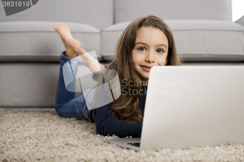 Image of Little girl working with a laptop
