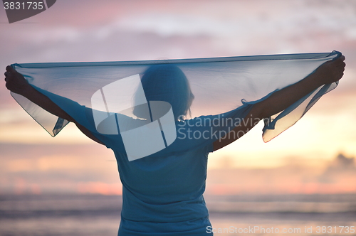 Image of Elderly woman at sunset