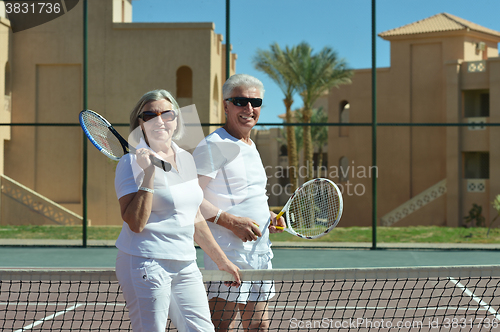 Image of senior couple on tennis court