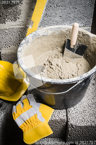 Image of Tools for bricklayer bucket with a solution and a trowel, close-