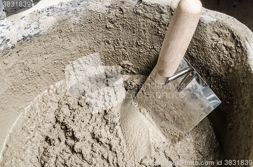 Image of A bucket with a solution and a trowel, close-up