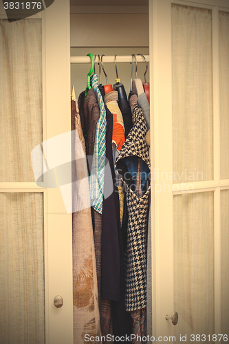 Image of white wardrobe with clothes