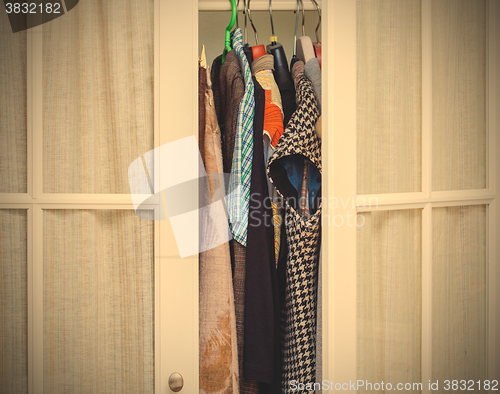 Image of clothes in a white wardrobe