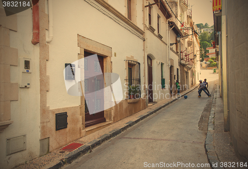 Image of Tossa de Mar, Spain, June 17, 2013: Children play with a ball