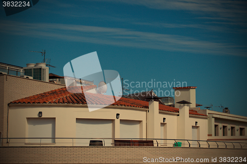 Image of white stone house with red tiled