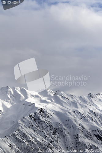 Image of Sunlight snowy mountains and cloudy sky