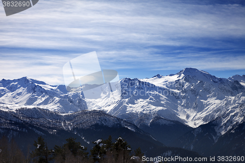 Image of Sunlight snowy mountains in wind morning