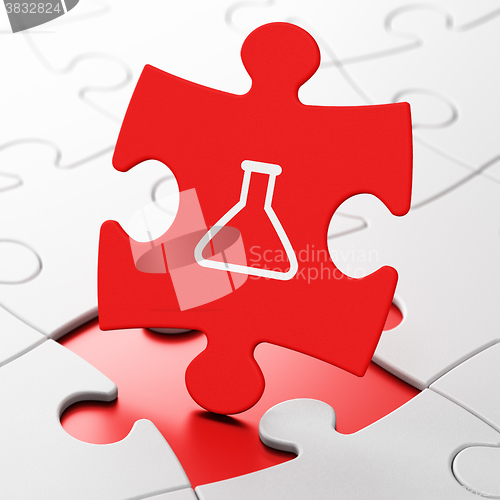 Image of Science concept: Flask on puzzle background