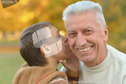 Image of Grandfather and grandson in park