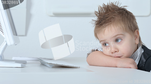Image of cute Little boy with computer