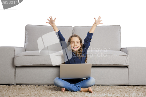 Image of Little girl working with a laptop