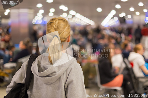 Image of Woman waiting on airport terminal.