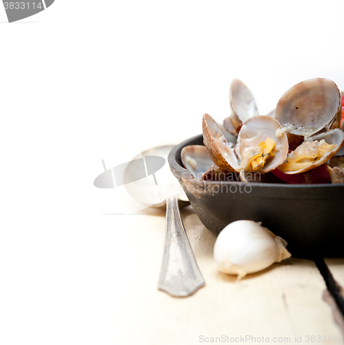 Image of fresh clams on an iron skillet