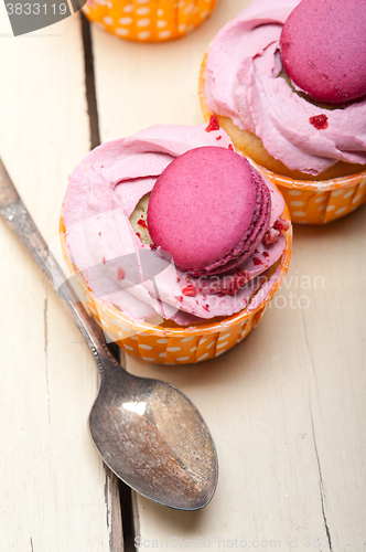 Image of pink berry cream cupcake with macaroon on top