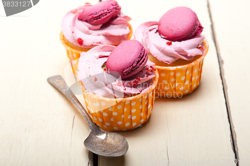 Image of pink berry cream cupcake with macaroon on top