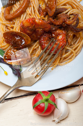 Image of Italian seafood spaghetti pasta on red tomato sauce 