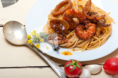 Image of Italian seafood spaghetti pasta on red tomato sauce 