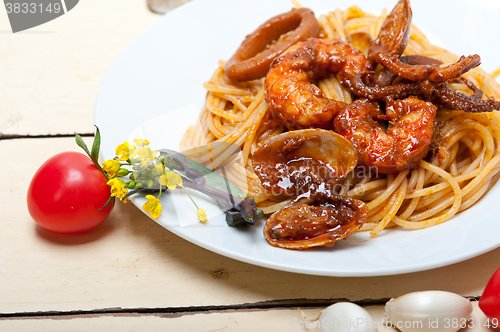 Image of Italian seafood spaghetti pasta on red tomato sauce 