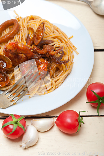 Image of Italian seafood spaghetti pasta on red tomato sauce 