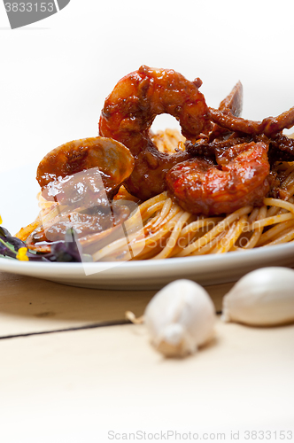 Image of Italian seafood spaghetti pasta on red tomato sauce 