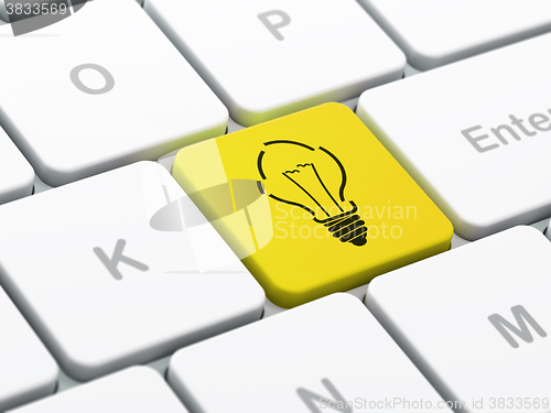 Image of Finance concept: Light Bulb on computer keyboard background