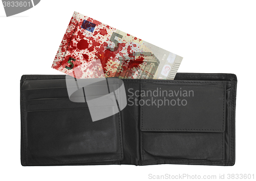 Image of Close-up of a 5 euro bank note, stained with blood