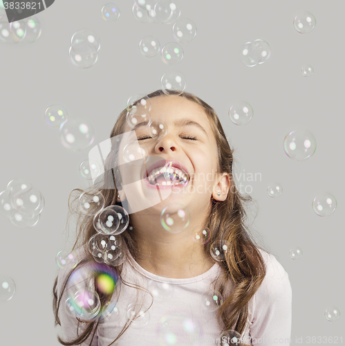 Image of Girl playing with soap bubbles