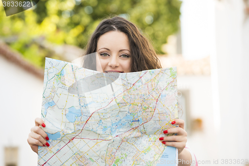 Image of Beautiful tourist searching on the map