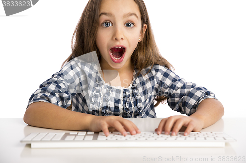 Image of Little girl working with a computer