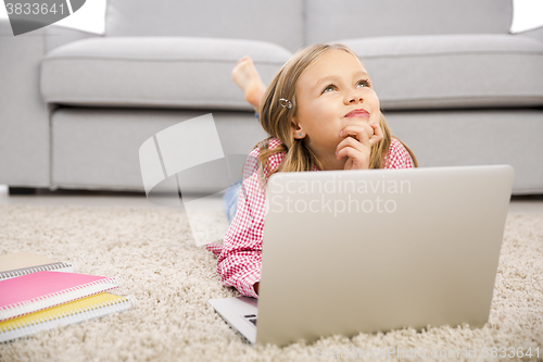 Image of Little girl working with a laptop