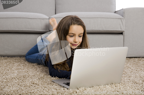 Image of Little girl working with a laptop