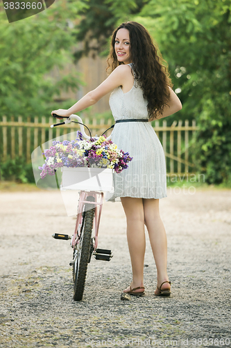 Image of Happy girl with her bicycle