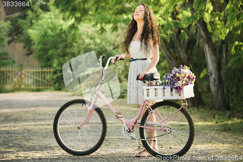 Image of Happy girl with her bicycle