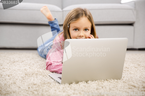 Image of Little girl working with a laptop