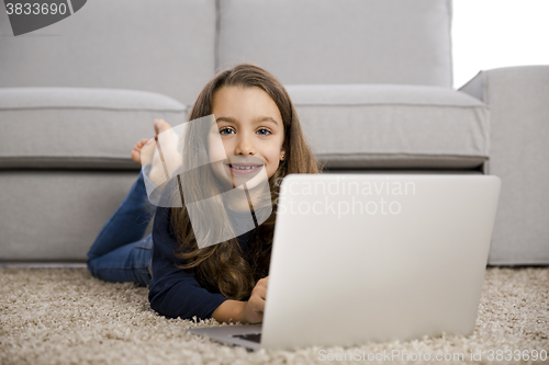 Image of Little girl working with a laptop