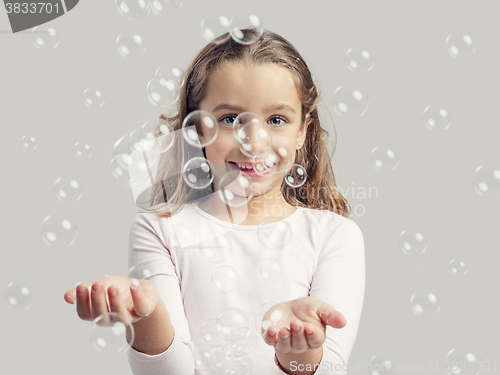 Image of Girl playing with soap bubbles