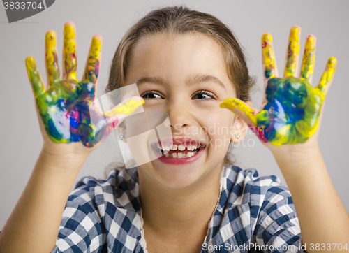 Image of Little girl with hands in paint