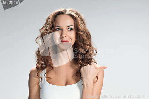 Image of The happy woman on gray background