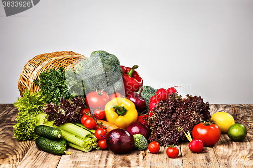 Image of The vegetables from a  basket on wooden table