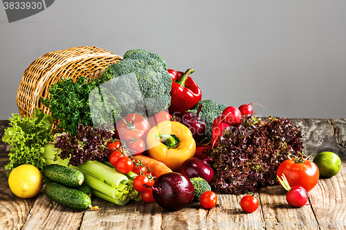 Image of The vegetables from a  basket on wooden table