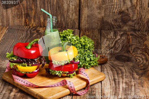 Image of The bottles with fresh vegetable juices on wooden table
