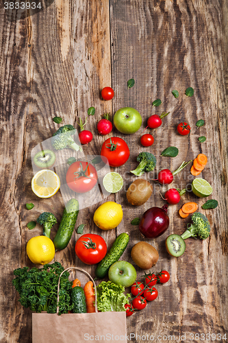 Image of The vegetables from a paper bag on wooden table