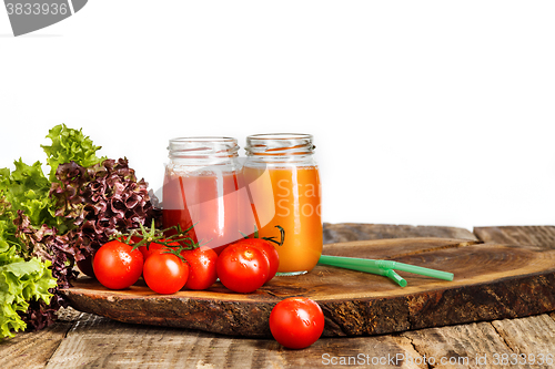 Image of The bottles with fresh vegetable juices on wooden table